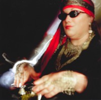 This is part of the Mystical Magical shoot. The model is decked out to tell fortunes with a crystal ball. Her blind eyes are covered by dark glasses.